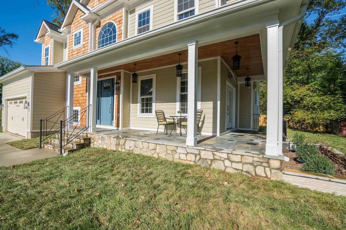 Finished home exterior by KAM Construction with new siding, stone accents and covered porch