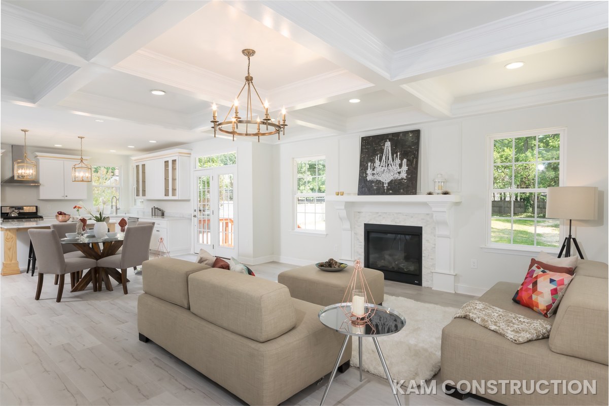 Great room with coffered ceiling opening to kitchen